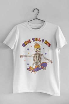 🖤 Product Details:- 100% Soft Ring-Spun Cotton- Light fabric that runs true to size- Unisex- Made in the USA 🇺🇸 🖤 Description:Embrace the spirit of the season and your passion for skateboarding with our 'Ride Till I Die' Halloween and Retro Skateboarding Lover Tee! Get ready to carve up the streets in style with this edgy and retro-inspired skate tee that's perfect for all you thrill-seekers out there. This hauntingly cool design features spooky graphics and vintage skateboard vibes, making Casual White Skateboarding T-shirt, White Casual T-shirt For Skateboarding, Trendy Crew Neck T-shirt For Skateboarding, Casual White T-shirt For Skateboarding, Trendy Graphic Print Tops For Skateboarding, White Graphic Skateboarding T-shirt, White Graphic T-shirt For Skateboarding, White Graphic Print T-shirt For Skateboarding, Crew Neck T-shirt With Sublimation Print For Skateboarding