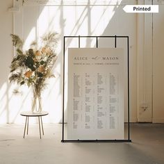 a vase filled with flowers next to a sign