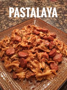 pasta with sausage and tomato sauce on a glass plate