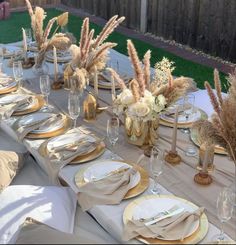 the table is set with place settings and gold chargers for dinner party guests to enjoy