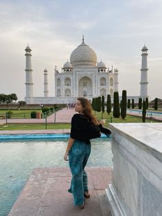 a woman standing in front of the tajwa