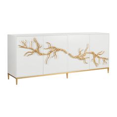 a white cabinet with gold branches on it