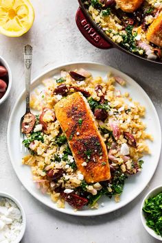 a white plate topped with fish and rice