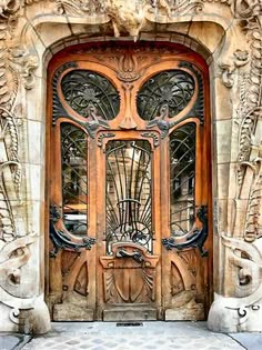 an ornate wooden door with glass panels