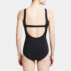 the back of a woman in a black swimsuit