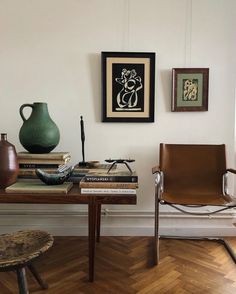 a table with books, vases and other items on it in a living room