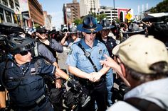 police officers standing in the middle of a crowd