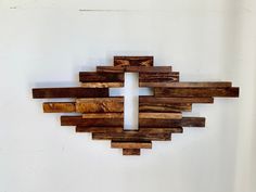 a cross made out of wooden planks on a wall