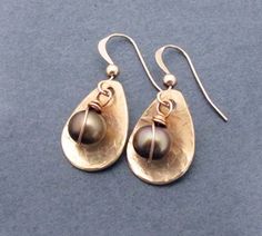 An ideal 8th anniversary or 19th anniversary gift for wife as bronze is the tradition for the occasion.  These lovely earrings feature genuine freshwater pearls in a bronze-tone color and hammered bronze teardrop dangles.  Petite and dainty meets rustic earthiness for a unique design.  Ear hooks are crafted in 14k rose gold filled wire.  Lightweight for all day comfort.  These earrings also make a great June birthday gift since pearl is June's birthstone.Earrings measure:Width - 1/2 of an inch a Elegant Brass Jewelry For Anniversary Gift, Bronze Pearl Drop Earrings For Gift, Nickel Free Teardrop Pearl Earrings For Anniversary, Nickel-free Teardrop Pearl Earrings For Anniversary, Hand Forged Dangle Pearl Earrings For Gifts, Rose Gold Teardrop Pearl Earrings For Anniversary, Bronze Cuff Bracelet, 19th Anniversary Gifts, Bronze Anniversary Gifts