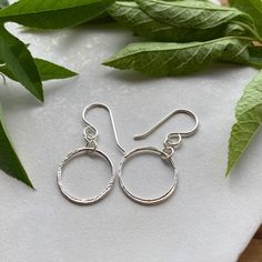 These uniquely shaped & organically textured circle hoops have lots of movement & sparkle!✦ All metal is bright sterling silver.✦ Circles have been given a unique hammered texture, and are organically shaped.✦ Circles measure 5/8" wide & just shy of 1 3/8" with French hook ear wires. They are 1 3/8" long with leverback ear wires. Adjustable Cadmium-free Sterling Silver Hoop Earrings, Small Hoop Hammered Sterling Silver Jewelry, Hammered Sterling Silver Small Hoop Jewelry, Everyday Sterling Silver Hammered Hoop Earrings, Hammered Open Circle Earrings For Everyday, Hammered Sterling Silver Hoop Earrings, Silver Dainty Hammered Hoop Earrings, Dainty Hammered Round Hoop Earrings, Dainty Hammered Silver Hoop Earrings