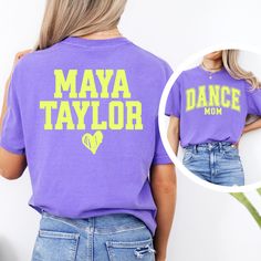 ⭐Stand out from the crowd and let everyone know you're the ultimate dance mom with this vibrant tee! 🩰This tee is sure to turn heads, featuring a bright and bold design that screams "proud mama!"  (Personalize it further by adding your little star's name(s) on the back for an extra dose of cuteness!)   🪩Whether you're cheering on your dancer at a competition or picking them up from class, this eye-catching tee is the perfect way to show your support in style. 🎁 Perfect Gift for Dance Moms IMP Purple Cotton Hip Hop Tops, Hip Hop Purple Top With Letter Print, Purple Hip Hop Top With Letter Print, Cotton T-shirt With Letter Print For Dance Class, Cotton Tops With Name Print For Dance, Cotton Dance Tops With Name Print, Hip Hop T-shirt With Letter Print For Dance Class, Dance Class Graphic Print Crew Neck T-shirt, Hip Hop Letter Print T-shirt For Dance Class