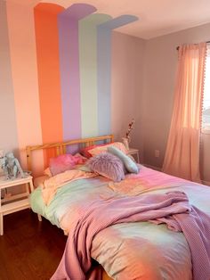 a bedroom with pink, blue and green striped walls