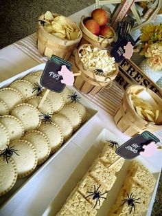 a table topped with lots of different types of snacks and desserts next to each other