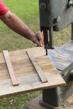 a person using a machine to cut wood