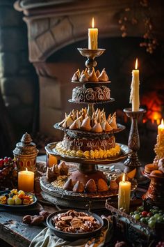 a table topped with lots of food and candles