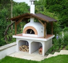 an outdoor pizza oven with wood stacked in it