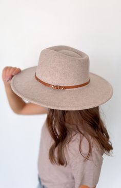 This wool wide brim hat with two interchangeable belts is the perfect addition to your wardrobe. Crafted from a wool blend, this stylish and timeless hat will elevate your look and give you a distinguished flair. Included with each hat are two belt color options: brown or black 10% wool, 90% polyester Beige Wide Brim Boater Hat For Fall, Beige Wide Brim Fedora For Winter, Beige Wide Brim Felt Hat, Chic Adjustable Wool Hat Band, Adjustable Solid Felt Hat For Everyday, Adjustable Felt Hat For Everyday Use, Chic Adjustable Boater Hat For Fall, Chic Adjustable Wool Hat, Chic Adjustable Hat Bands For Winter