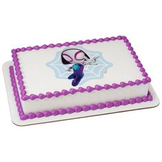 a white and purple cake with an image of a spiderman on it