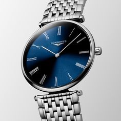 Launched in 1992, La Grande Classique de Longines has played a major role in forging the reputation of the winged hourglass brand. This range is a symbol of Longines’ classic elegance and timeless sophistication, and stands out thanks to its very slim profile and wide palette of versions. Elegant Blue Watch Accessories With Diamond Hour Markers, Elegant Blue Watches For Formal Occasions, Timeless Round Watches With Polished Finish, Timeless Blue Watches For Formal Occasions, Elegant Blue Jewelry And Watches For Formal Occasions, Timeless Blue Watch Accessories For Formal Occasions, Timeless Blue Watch Accessories For Formal Wear, Elegant Blue Watch Accessories With Polished Finish, Luxury Blue Watch With Polished Finish