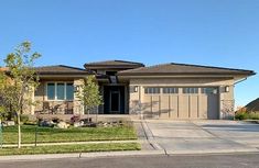 a large house with two garages in the front yard