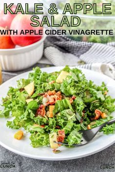 kale and apple salad with apple cider vingerette on a white plate