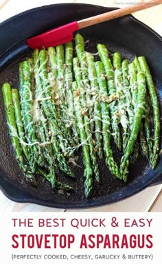 asparagus being cooked in a cast iron skillet