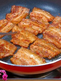 some meat is cooking in a pan on the stove