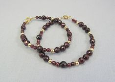 Genuine dark red garnet beads accented with bright 14K yellow gold beads and clasp create a warm, rich semiprecious bracelet. Garnet is the birthstone for January and these 6mm faceted and 4mm smooth natural stones have a beautiful burgundy color. The bracelet closes with a spring ring clasp and several lengths are available.  It's gorgeous enough to wear all by itself and would also make a beautiful addition to your stacking bracelet favorites!  Free USPS first class domestic shipping. The matc Garnet Bead Bracelet, Pink Pearl Bracelet, January Birthday Gifts, January Birthday, Buy Bead, Semi Precious Jewelry, Purple Pearl, Red Burgundy, Custom Necklace