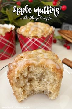 apple muffins with glaze drizzle on a plate next to cinnamon sticks