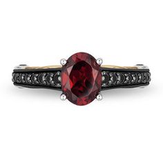 a ring with a red stone and black diamonds