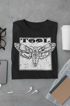 Tool Band Shirt|Tool Band Tour 2023 Concert Outfit Ticket Merch Sticker Creed Band Rage Against the Machine Unisex Jersey Short Sleeve Tee This classic unisex jersey short sleeve tee fits like a well-loved favorite. Soft cotton and quality print make users fall in love with it over and over again. These t-shirts have-ribbed knit collars to bolster shaping. The shoulders have taping for better fit over time. Dual side seams hold the garment's shape for longer.  .: 100% Airlume combed and ringspun cotton (fiber content may vary for different colors) .: Light fabric (4.2 oz/yd² (142 g/m .: Retail fit .: Tear away label .: Runs true to size Band Shirt Design Ideas, Band Tshirt Design Ideas, Tool The Band, Band Shirt Outfits, Tool Concert, Band Merch Ideas, Creed Band, Band Shirt Ideas, Merch Inspiration