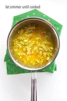 a pot filled with pasta on top of a green napkin