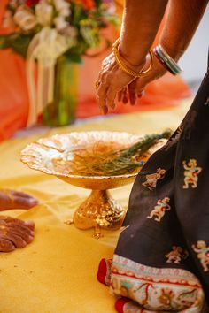 a woman is reaching for something on a plate