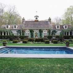 a pool in front of a large house