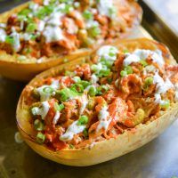 two stuffed sweet potatoes on a baking sheet