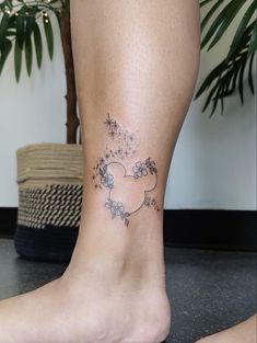 a woman's foot with a star and heart tattoo on her left side leg