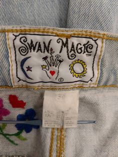 "Wonderful embroidered detail on these Magic Swan jeans. Button front fly 100% cotton, made in USA. Size says 11/12 but please go by measurements - convo me if I've missed something you need. No alterations have been done. Please see the close-up pics for holes as found (all natural). Waist 32\" Hips 47\" Rise 13\" Thigh circumference 24\" Inseam32\" Leg length waistband to hem 42.5\" Hem circumference 14\" wt 20 oz 2 lbs to ship" Hippie Cotton Jeans With Pockets, Light Wash Cotton Jeans For Festival, Bohemian Medium Wash Cotton Jeans, Light Wash Cotton Jeans With Floral Embroidery, Summer Embroidered Cotton Jeans, Retro Cotton Jeans With Buttons, Retro Cotton Jeans With Button Closure, Fitted Cotton Jeans With Multicolor Embroidery, Fitted Cotton Hippie Jeans