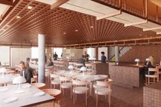 people are sitting at tables and eating in a restaurant with wood ceilinging on the walls