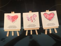 three cards with hearts on them sitting on easels