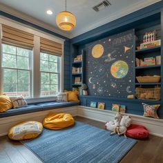 a child's room with blue walls and yellow pillows