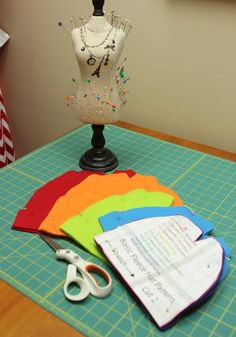 sewing supplies are sitting on a table next to a mannequin's torso