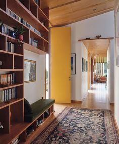 a room with bookshelves and a rug on the floor in front of it