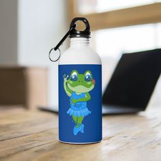 a water bottle sitting on top of a wooden table next to a laptop computer in the background