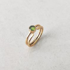 Materials: 18k Gold, Silver Stone: Natural Peridot Stone Size: 5mm Ships Worldwide from India 925 stamped Handmade Item About Gold Vermeil The ring is made up of 925 Sterling Silver with a 2 micron 18k gold plating which make the ring a daily wear and a long lasting plating.  STYLE STATEMENT Engaging, stylish, this band is crafted for the modern-day woman! A Warrior of her own right and someone who is unafraid to face any challenge. The unique shape and edgy design of this ring is something that Minimalist Gold Emerald Stackable Ring, Minimalist Gold Stackable Rings With Emerald, Minimalist Gold Stackable Rings For May Birthstone, Minimalist Gold Emerald Ring With Round Band, Gold Stackable May Birthstone Rings, Minimalist Gold Ring, Edgy Design, Peridot Stone, Etsy Gold Ring