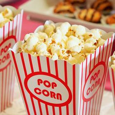 two popcorn bags filled with popcorn sitting on top of a table