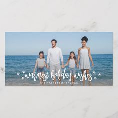 a family photo with the words warmest holiday wishes in white and blue on it