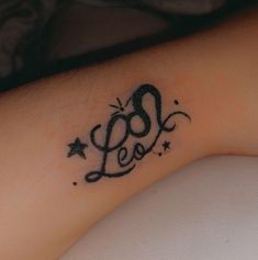 a tattoo on the arm of a woman with stars and an inscription that says love