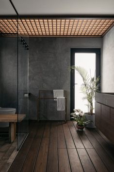 a bathroom with a wooden floor and large window