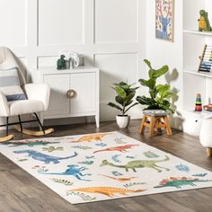 a child's room with white furniture and dinosaur rugs on the wooden floor