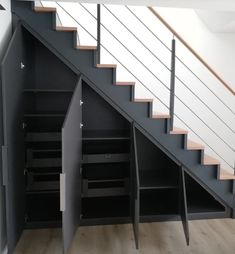 an open storage compartment under the stairs in a house